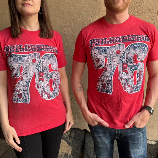 Two people standing beside each other, both wearing red Paul Carpenter Sixers T-Shirts with a detailed