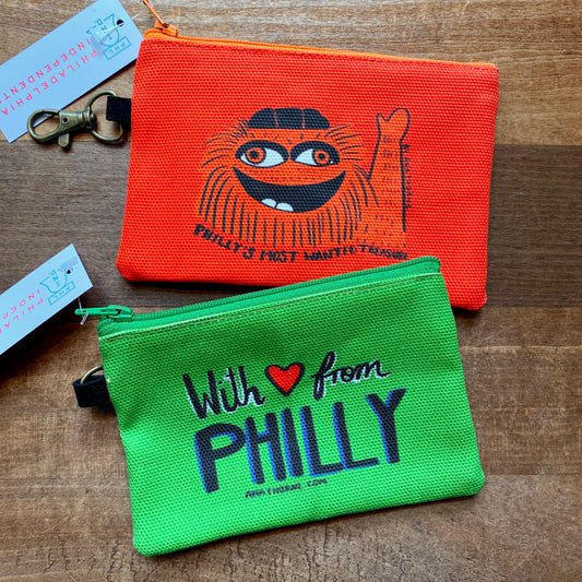 Two colorful Ana Thorne Gritty & Phanatic zipper pouches with
