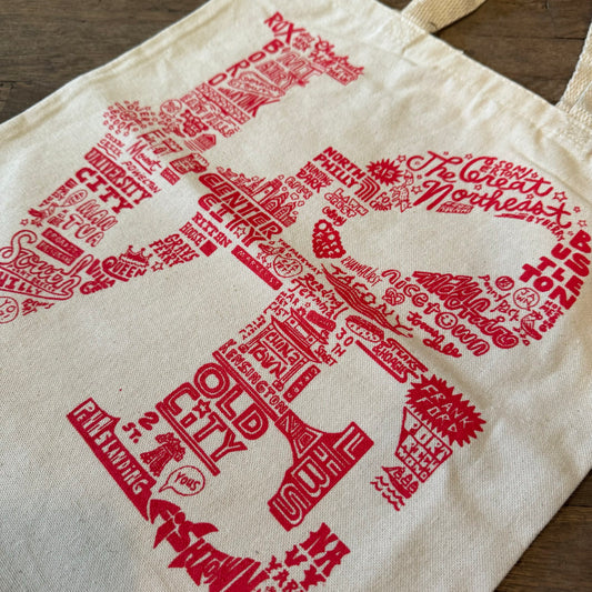 A Paul Carpenter LOVE Tote Bag with a typographic design forming the shape of the United States and featuring