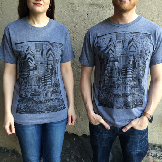Two people wearing matching Paul Carpenter Philadelphia Skyline T-Shirts with a detailed graphic of the Philadelphia skyline.