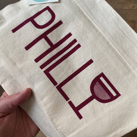 A hand-screenprinted canvas tote bag with the word