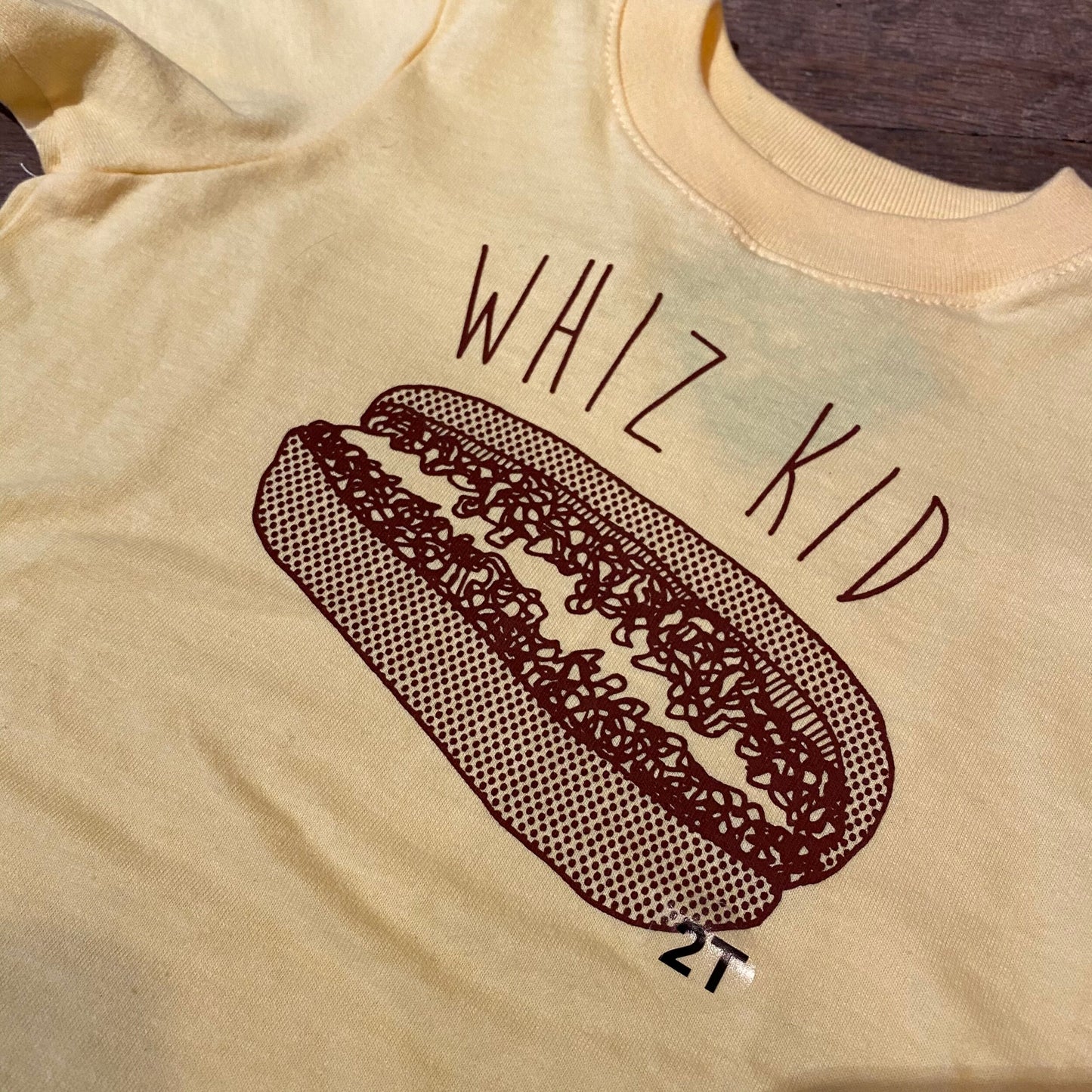 Yellow Whiz Kid Toddler T-Shirt with a hot dog graphic and the phrase "Philly genius" printed on it by exit343design.