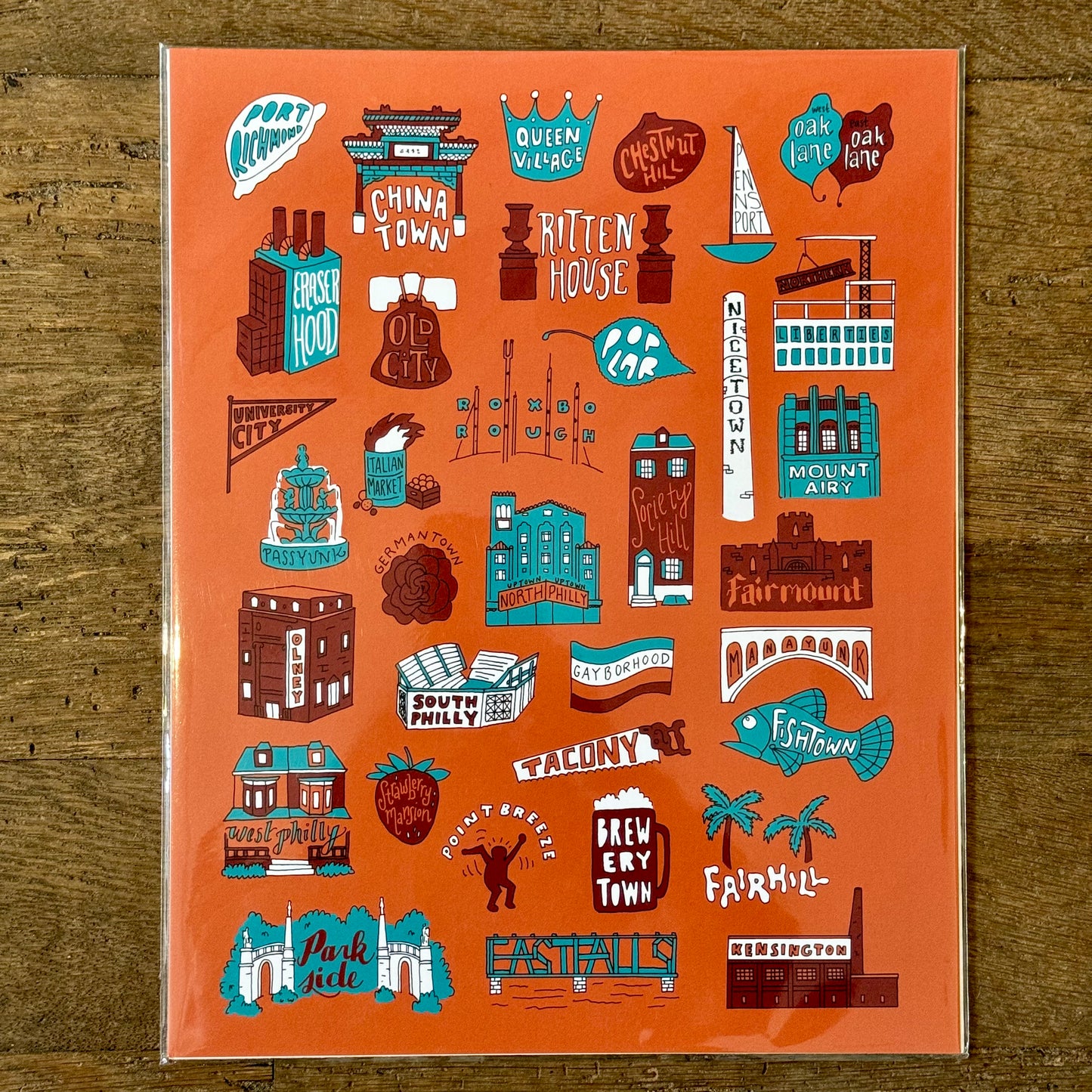 Introducing Philadelphia Prints by Kate Otte: This vibrant illustration on a striking orange background showcases stylized names and iconic buildings from various Philadelphia neighborhoods, including China Town, Rittenhouse, Fairmount, and more—an ideal addition for fans of Philly-themed art.