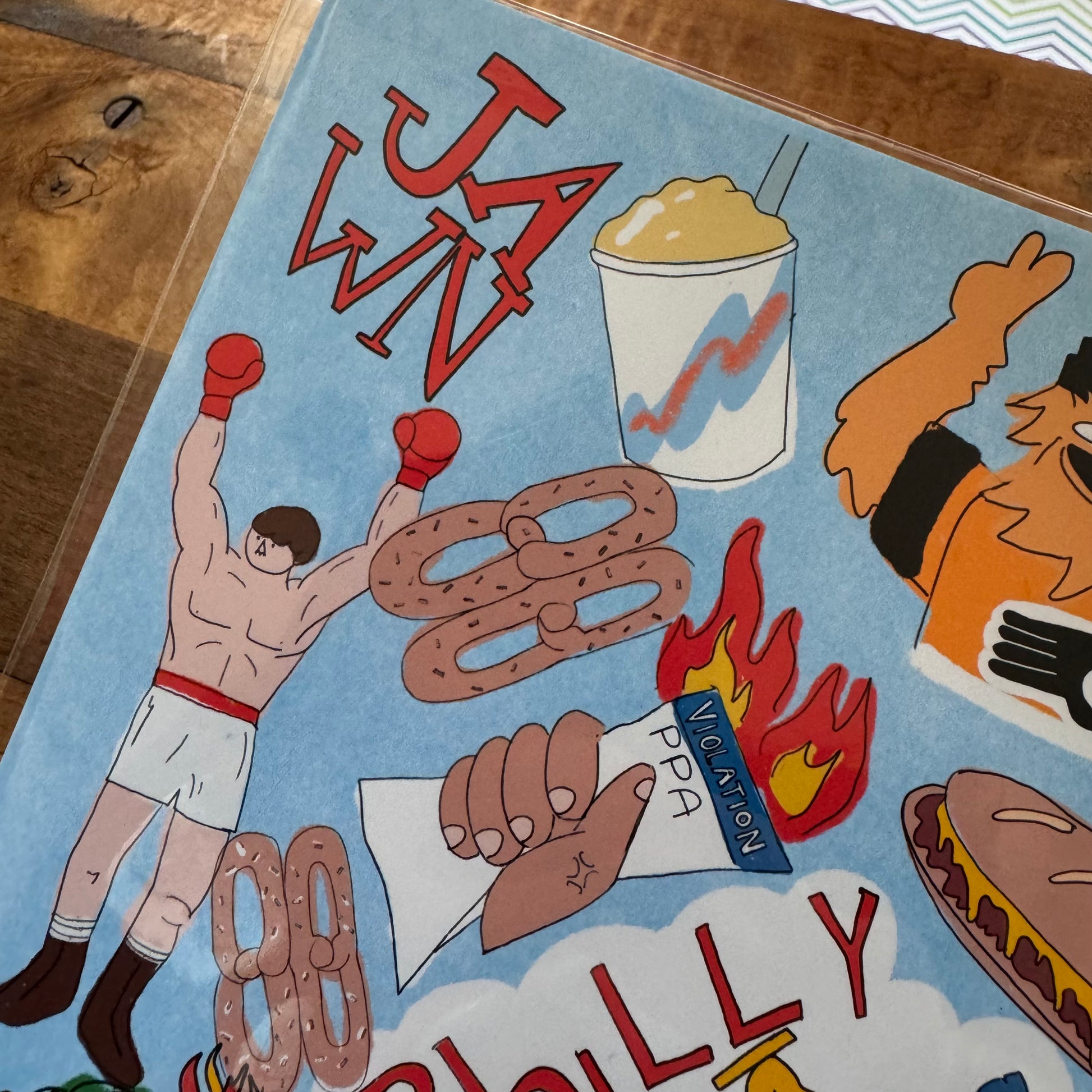 The Philly Things Print by LizPopArt features a vibrant illustration with a boxer, a drink, a hand holding a pretzel with cheese, and the text "JAWN." Additional elements include a flaming hot dog and a hand holding an envelope labeled "Violation" on fire. Perfect for fans of Philly prints, it's available on professional matte premium paper.