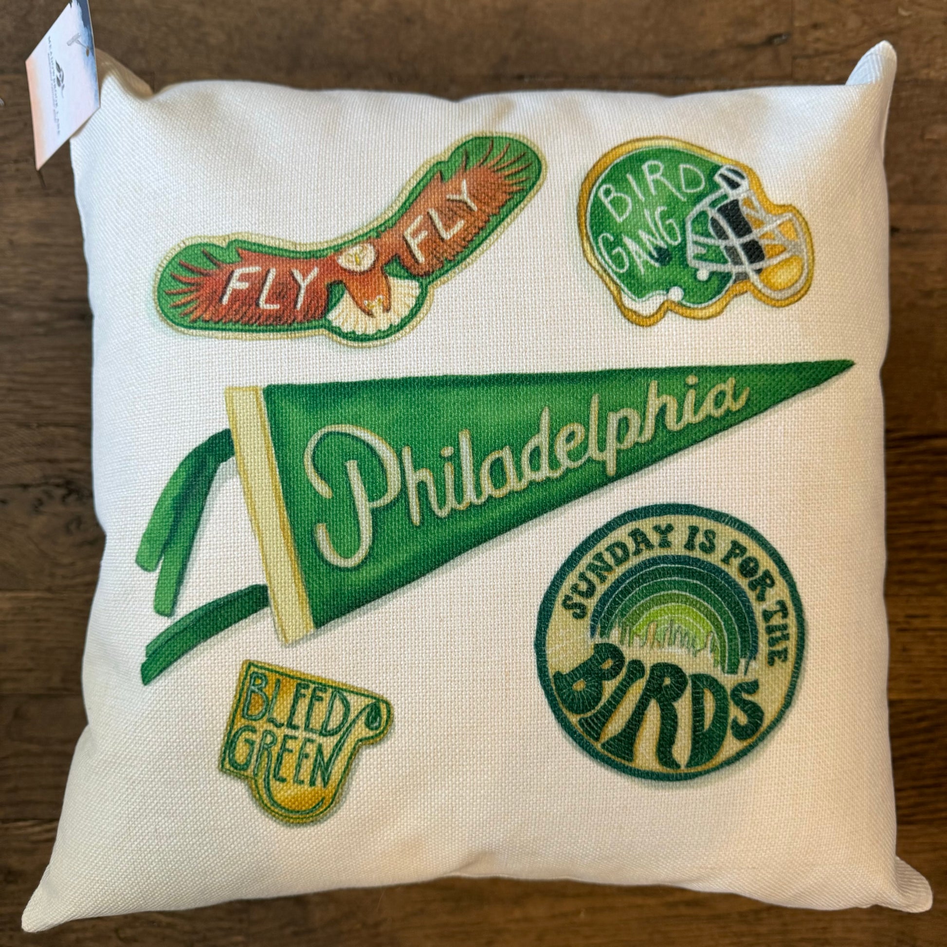 The Philly Illustrated Pillows collection by Meadowbrook Lane features a decorative pillow adorned with Eagles-themed designs such as "Fly Eagles Fly," "Bird Gang," "Philadelphia" on a pennant, "Sunday Is For The Birds," and "Bleed Green" patches. Perfect for adding a spirited touch to any fan's space.