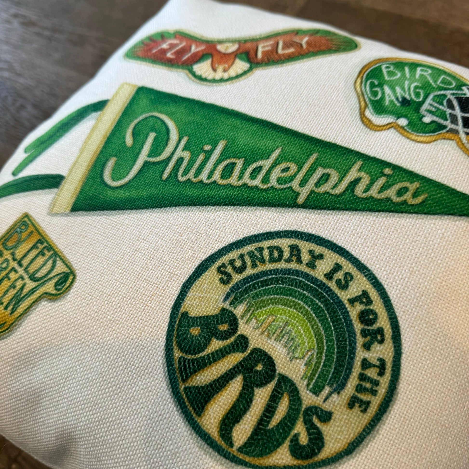 The Philly Illustrated Pillows by Meadowbrook Lane feature a variety of Philadelphia-themed designs, such as a pennant displaying "Philadelphia" and phrases like "Fly Eagles Fly" and "Sunday is for the Birds." These decorative pillows are perfect for fans looking for unique Philadelphia pillows.