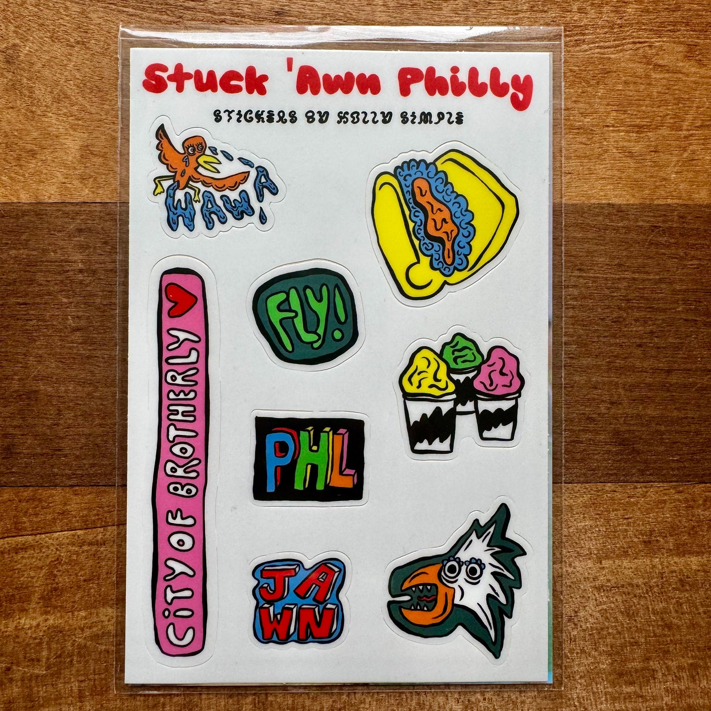 Introducing the Philly Sticker Packs by Holly Simple! This vibrant sticker collection features a variety of Philadelphia-themed designs, including a pretzel, ice cream, "City of Brotherly Love," "Fly!" and other iconic imagery from the city.