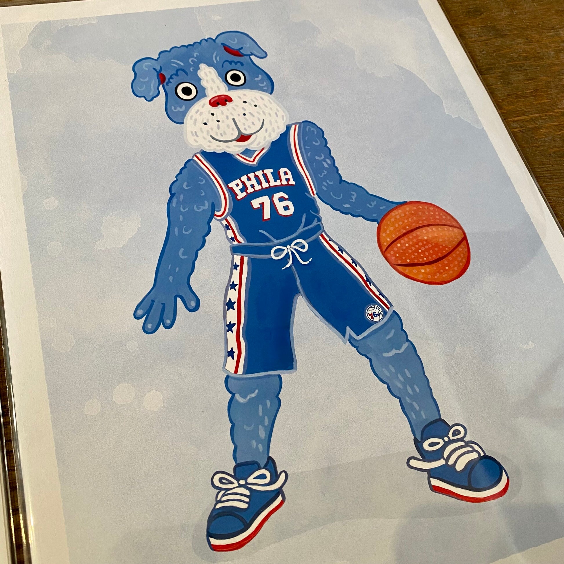 Illustration of a canine character dressed in a Philadelphia 76ers basketball uniform, dribbling a basketball by Jamie Bendas as part of the Philly Mascot Prints collection.