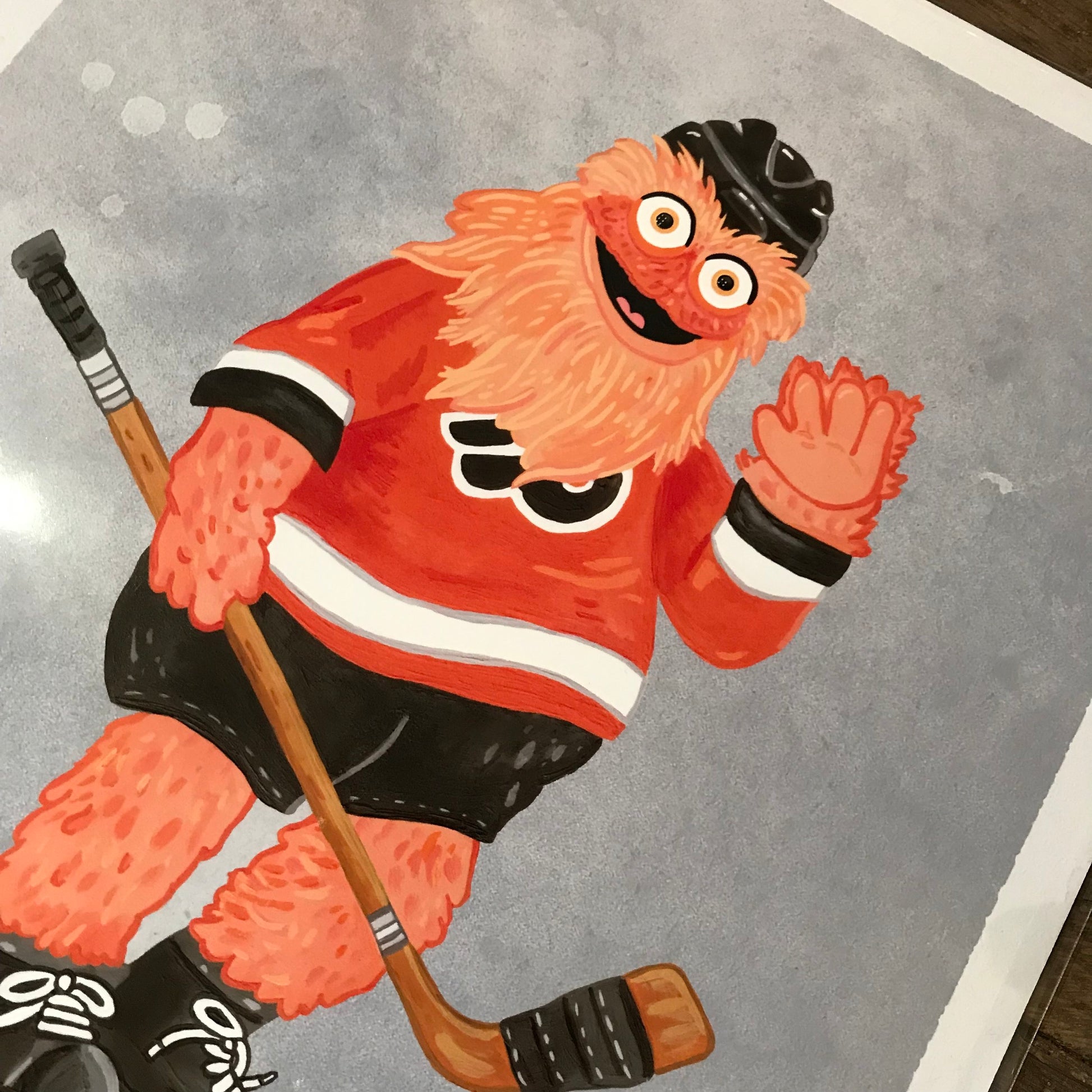 Illustration of cartoon character Philly Mascot Prints dressed as a hockey player, smiling and waving.