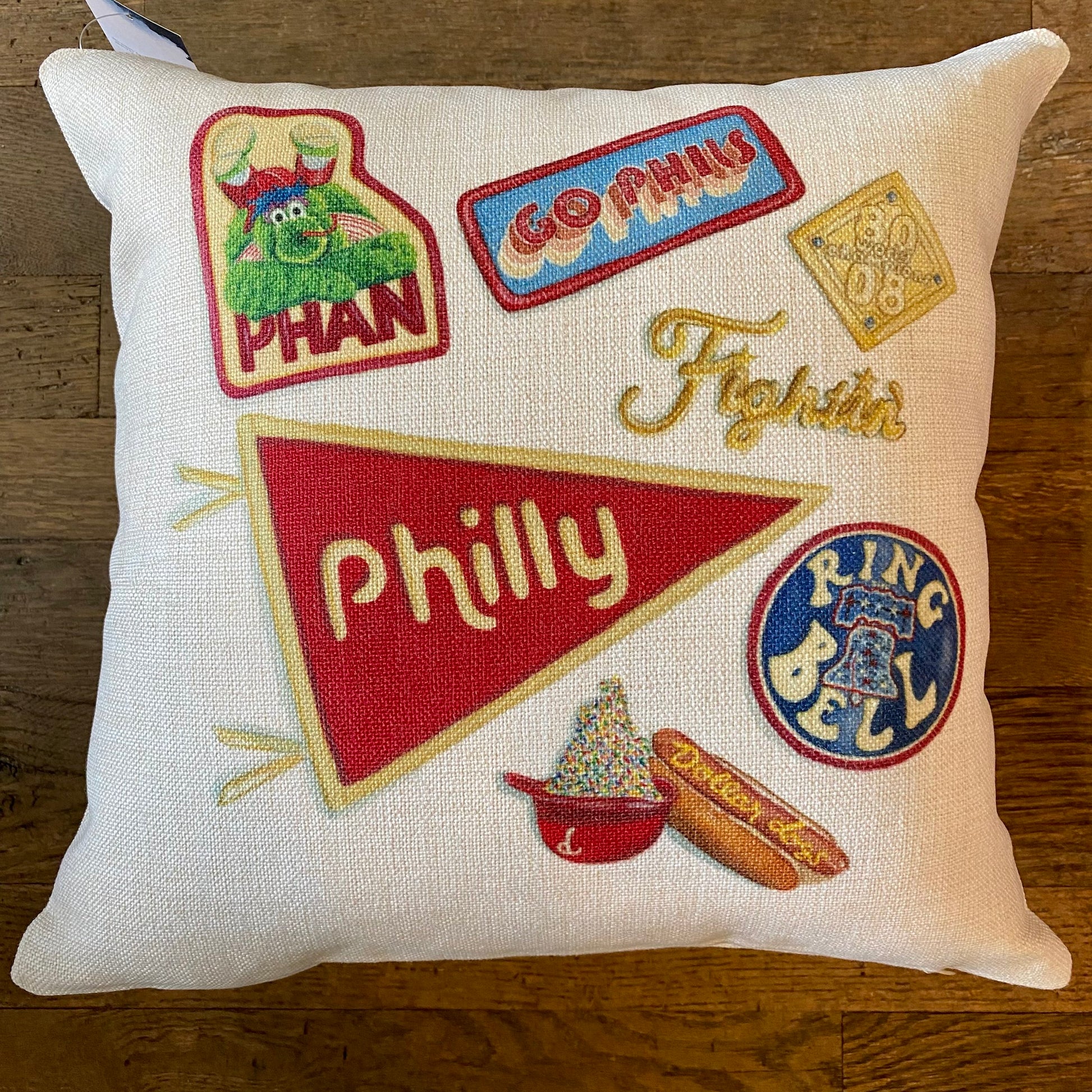 Decorative pillow featuring Philly Illustrated Pillows patches, including Eagles fan designs, sports, and local symbols by Meadowbrook Lane.