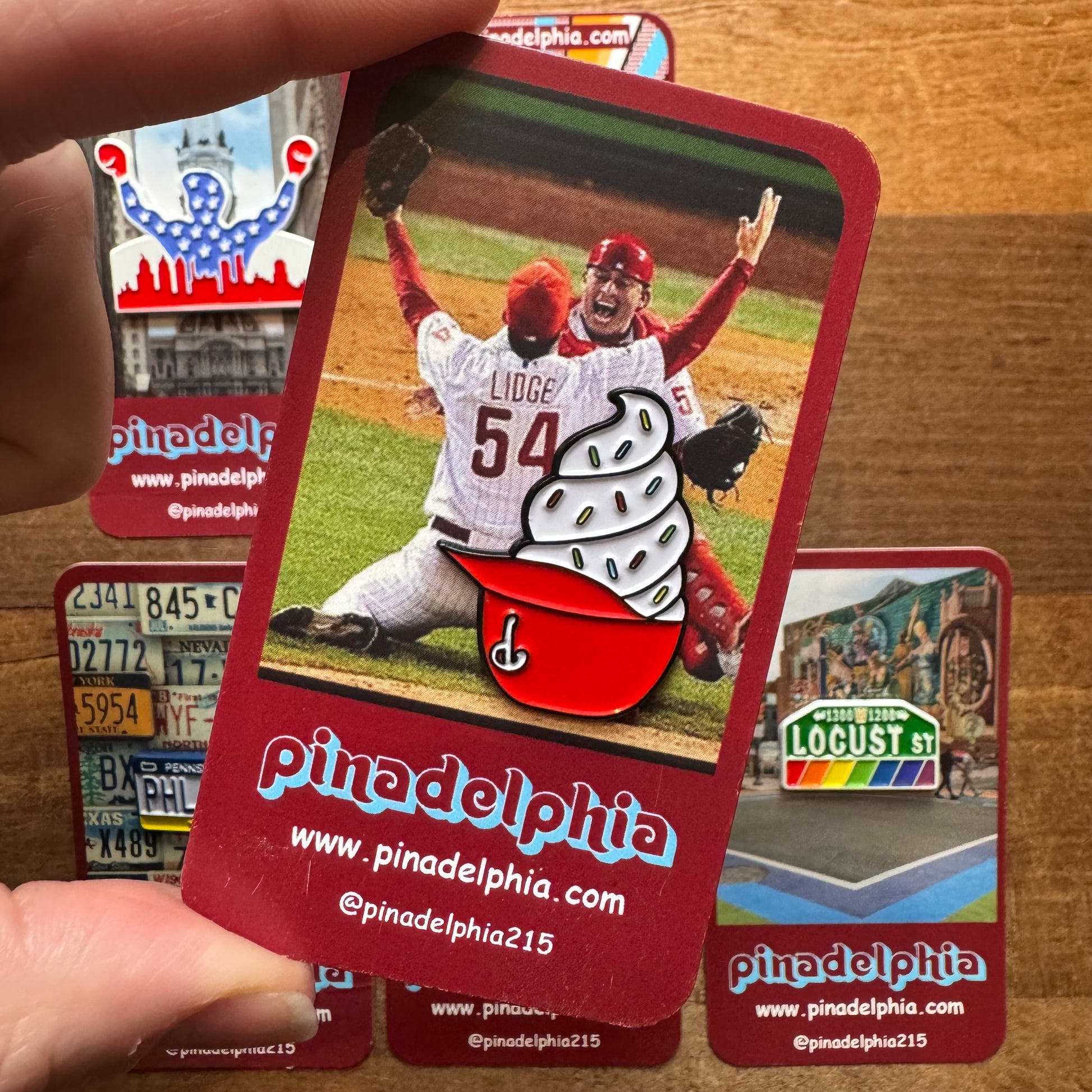 Pinadena's Philly-Themed Enamel Pins II, showcasing a player celebrating and an impressive collection of enamel pins, radiates Philly pride.