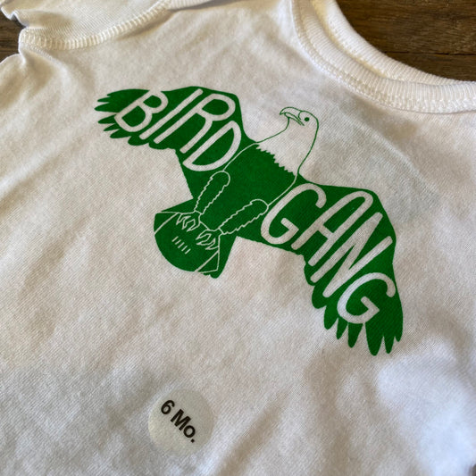 100% cotton Bird Gang Baby Onesie with a green eagle graphic and the words 