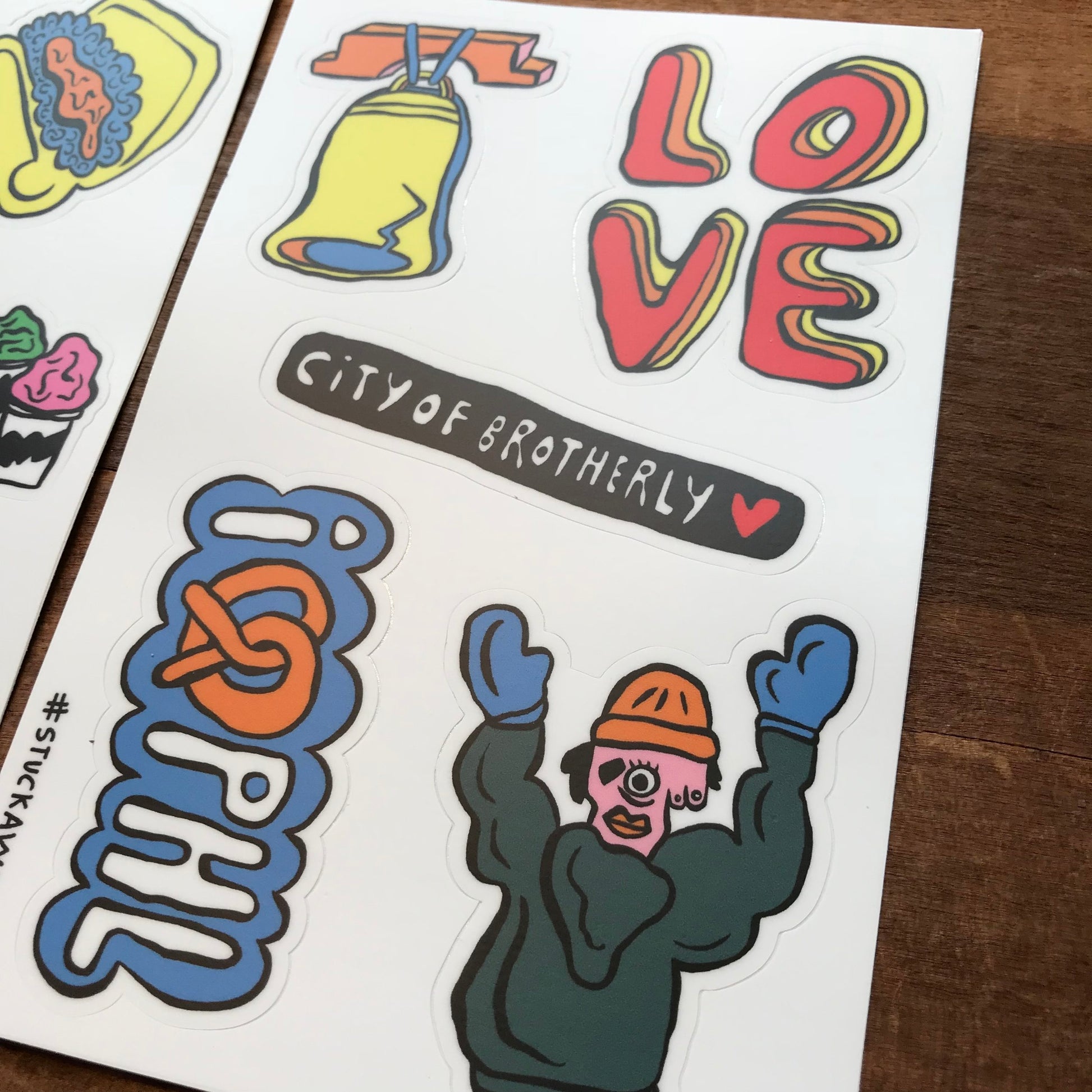 A collection of colorful stickers with various designs, including one Philly Sticker Packs with the word "love" and another referencing Holly Simple-themed sticker packs.