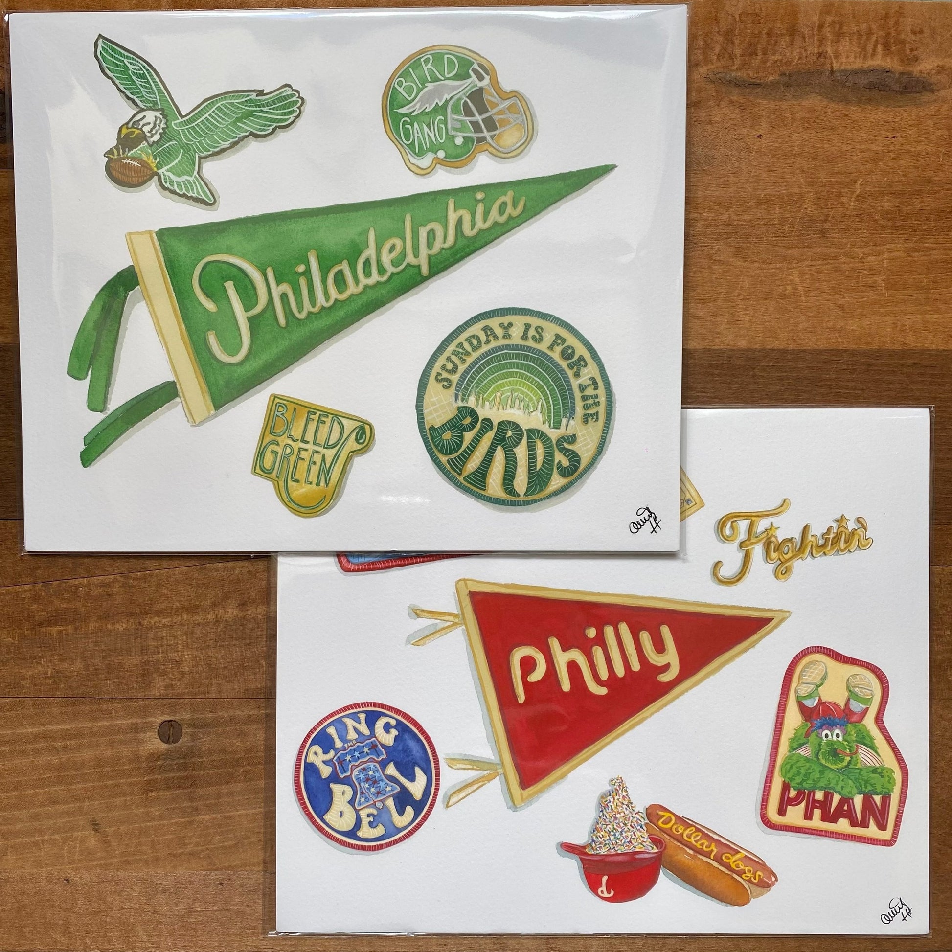 A collection of Philly sports fan-themed stickers showcasing sports team logos and local references on fine art paper by Meadowbrook Lane's Philly Sports Prints.