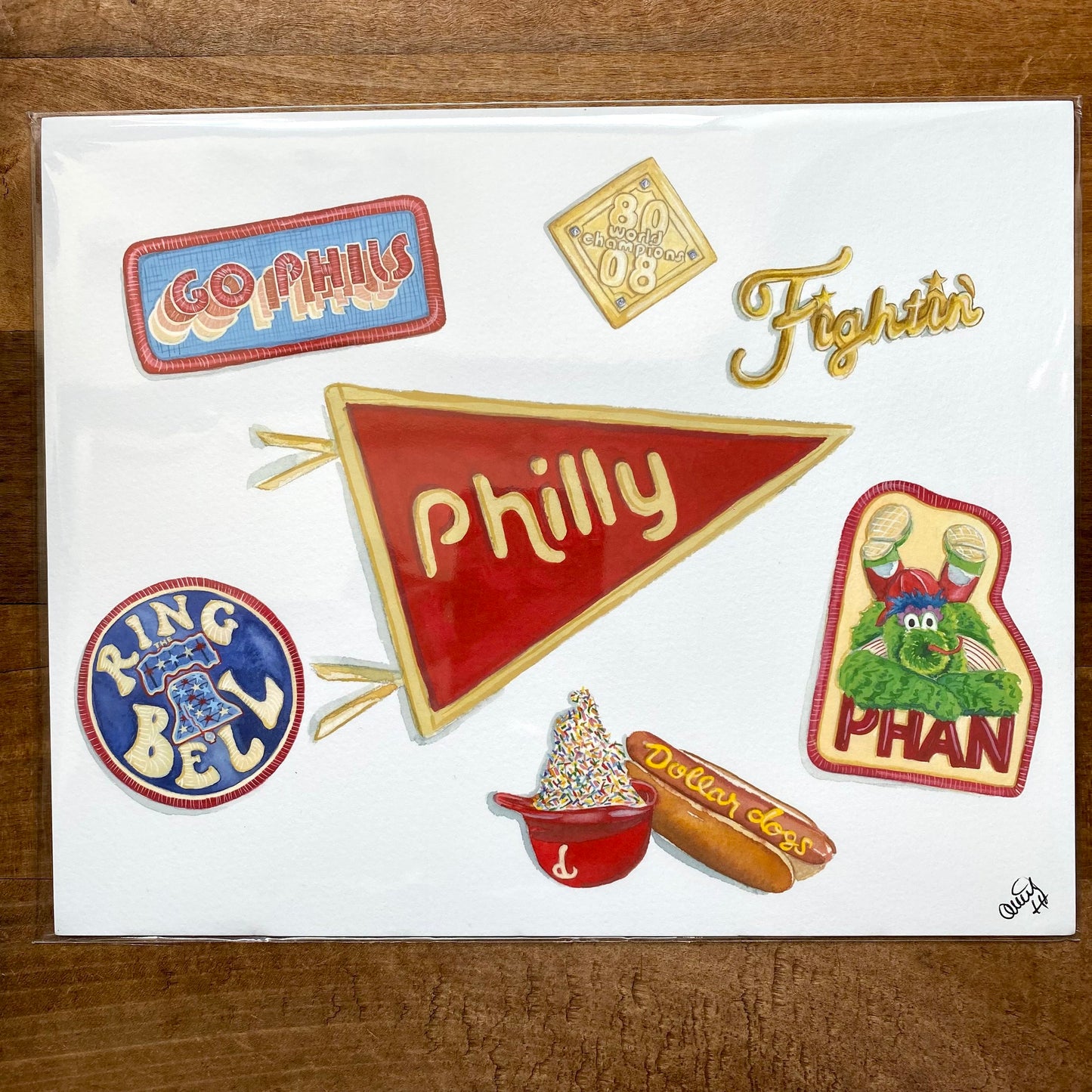 An illustration of Philadelphia-themed items and symbols on fine art paper, including a 'Philly' pennant, a cheesesteak, a 'ring bell', and Philly Sports Prints references.