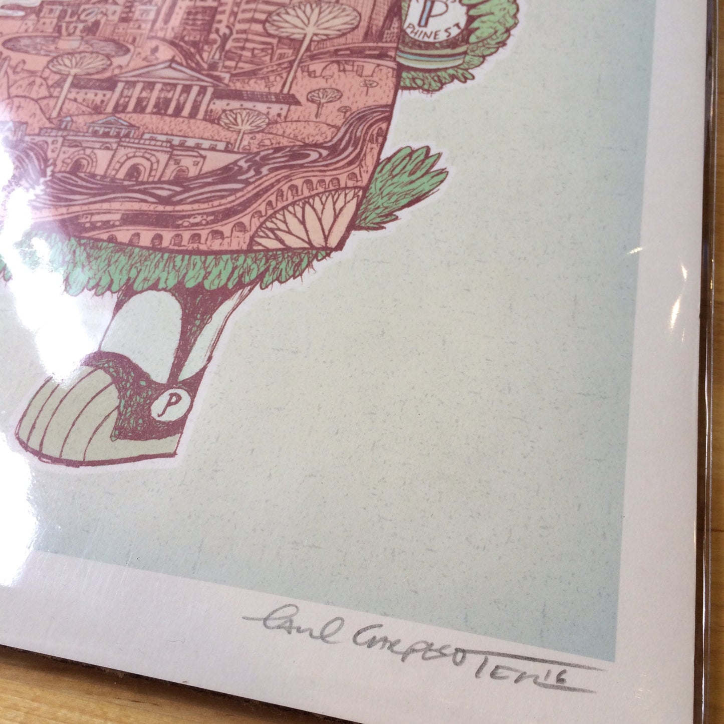 Art print of a whimsical drawing featuring architectural elements and the Philly skyline, signed by Paul Carpenter in 2016, encased in a clear protective sleeve.