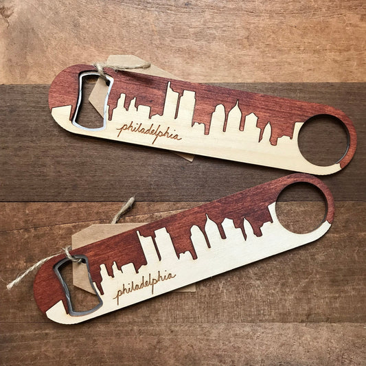 Two Philly Bottle Openers with laser-etched cutouts of Philadelphia's skyline and the city's name on them by Philly Phlights.