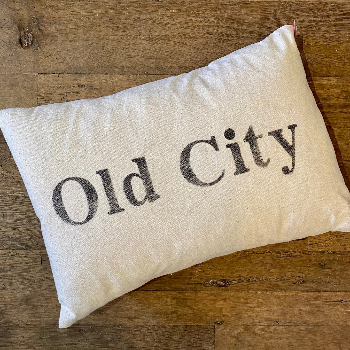 Embroidered Old City Pillows with "Old City Philly" text on a wooden background by The Pillow Works.