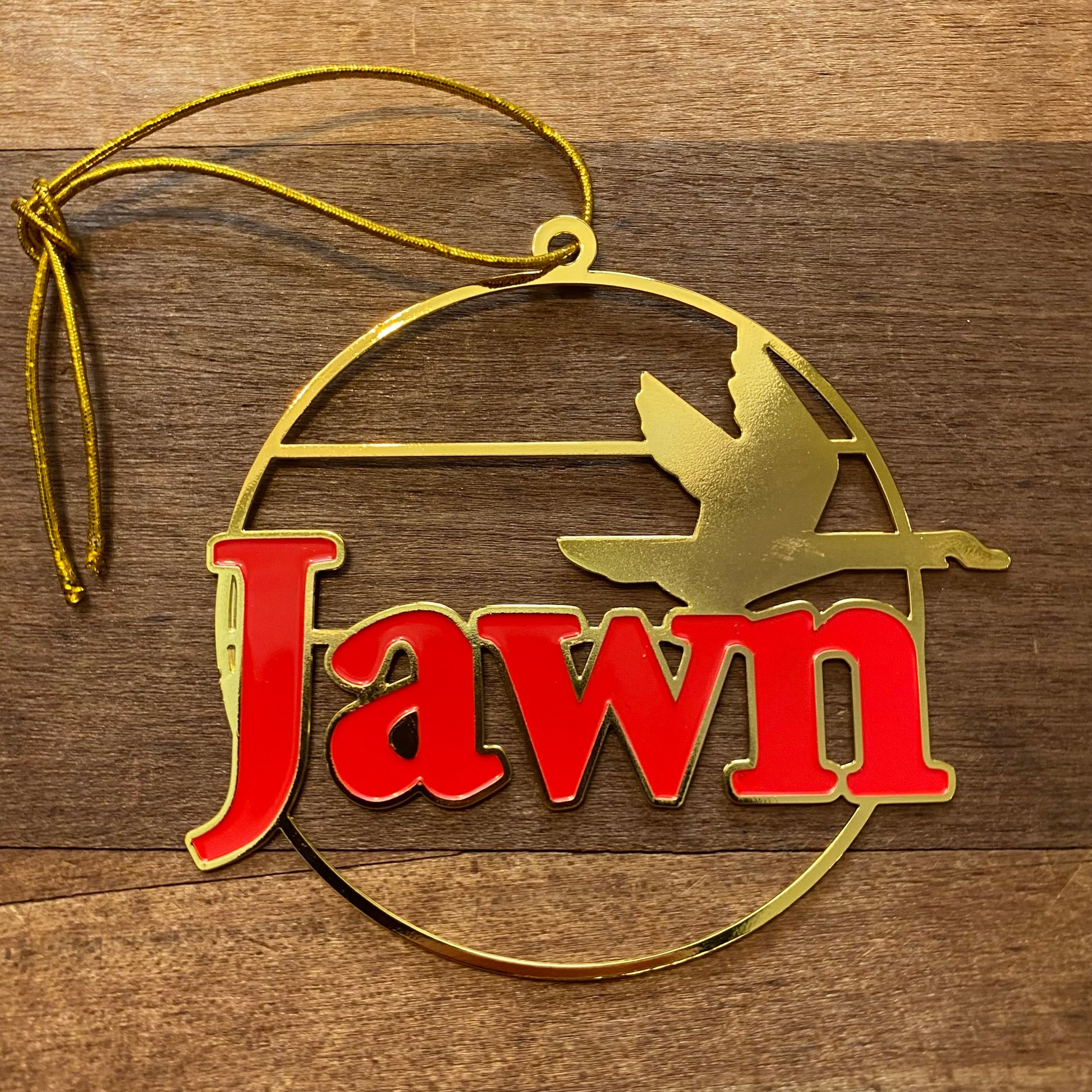 Gold and red Jawn Ornament with the word "jawn" and a silhouette of a flying bird, featuring the South Fellini logo.