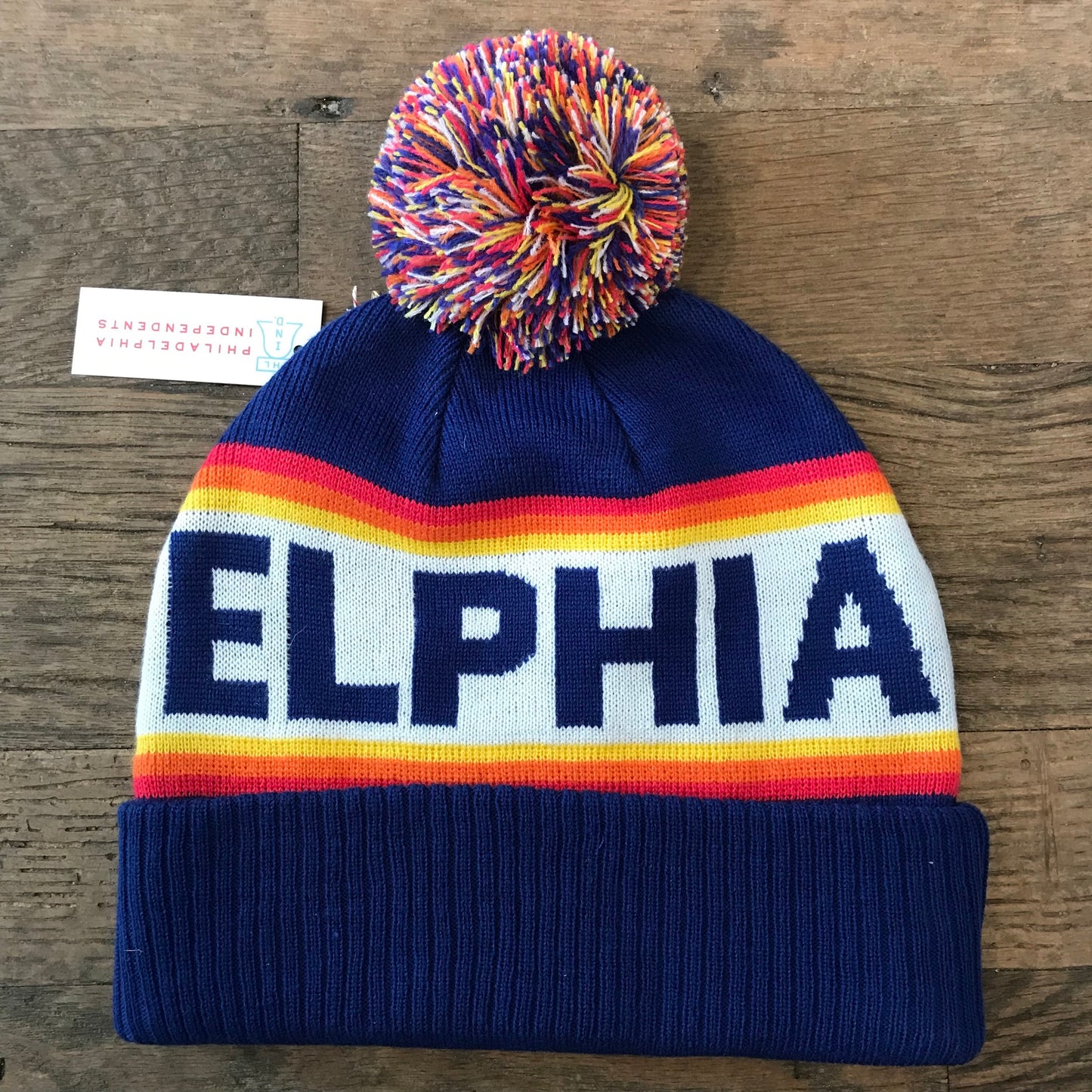 A colorful double-sided knit hat with a pompom on top and the word "Philadelphia Beanie," symbolizing the City of Brotherly Love, emblazoned on the brim by South Fellini.