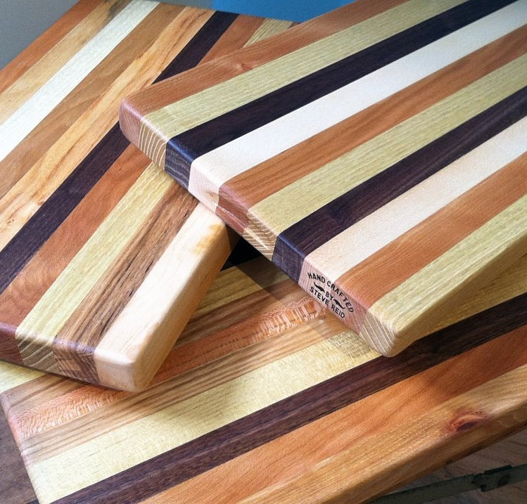 Handcrafted Striped Wood Cutting Boards and presentation boards with different grain patterns and wood types, including reclaimed wood by Steve Reid.